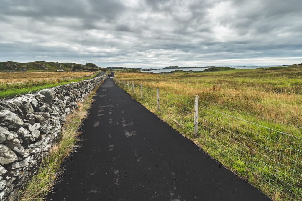 Asphalt road along the fields. Northern Ireland.